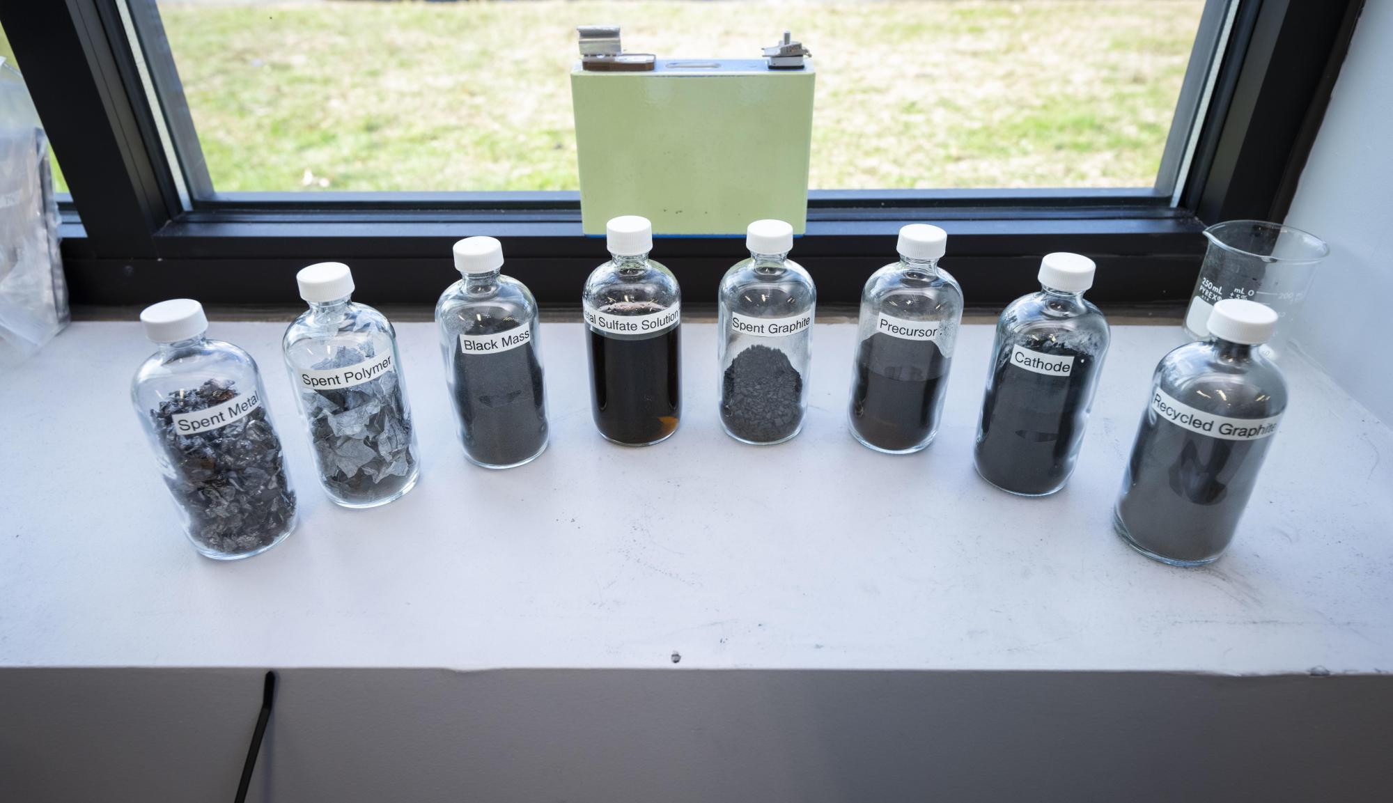 Small clear bottles of recycled battery material