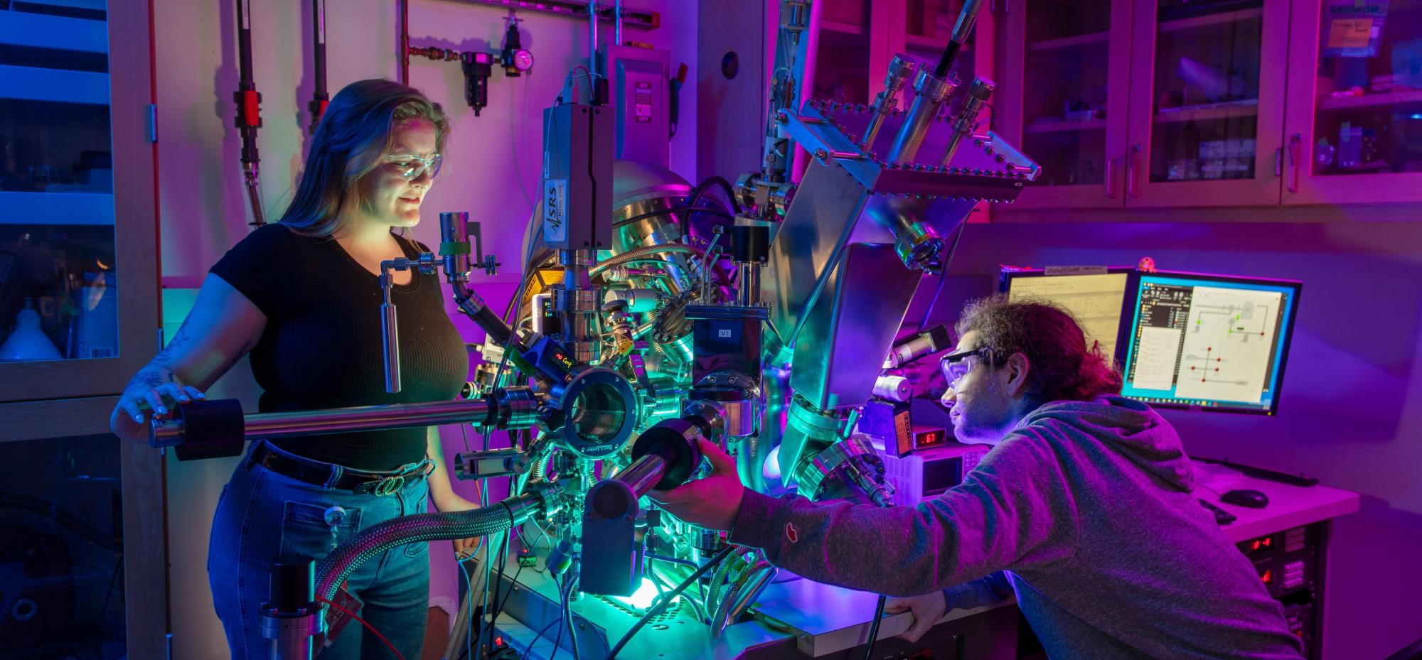 Two scientists using chemistry lab equipment