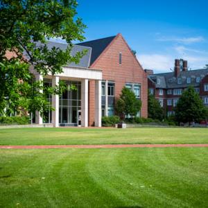 Green grass and view of the front of the Barlett Center