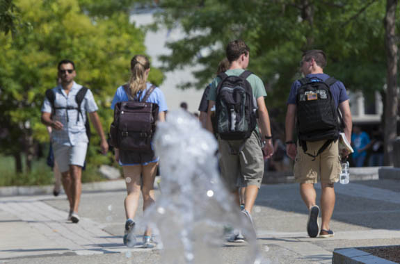 students walking in the fountain wpi
