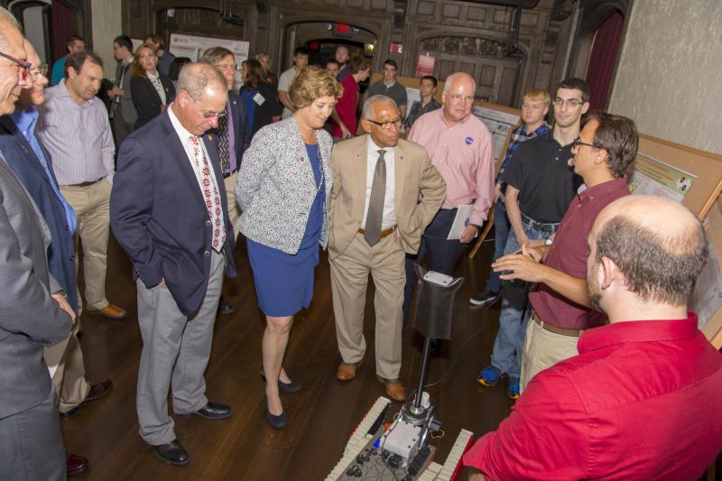 Nasa Administrator Charles Bolden, WPI President Laurie Leshin, and Director of Robotics Engineering Michael Gennert in front of the WALRUS robot, speaking to Robotics students at the Higgins House Robotics Showcase