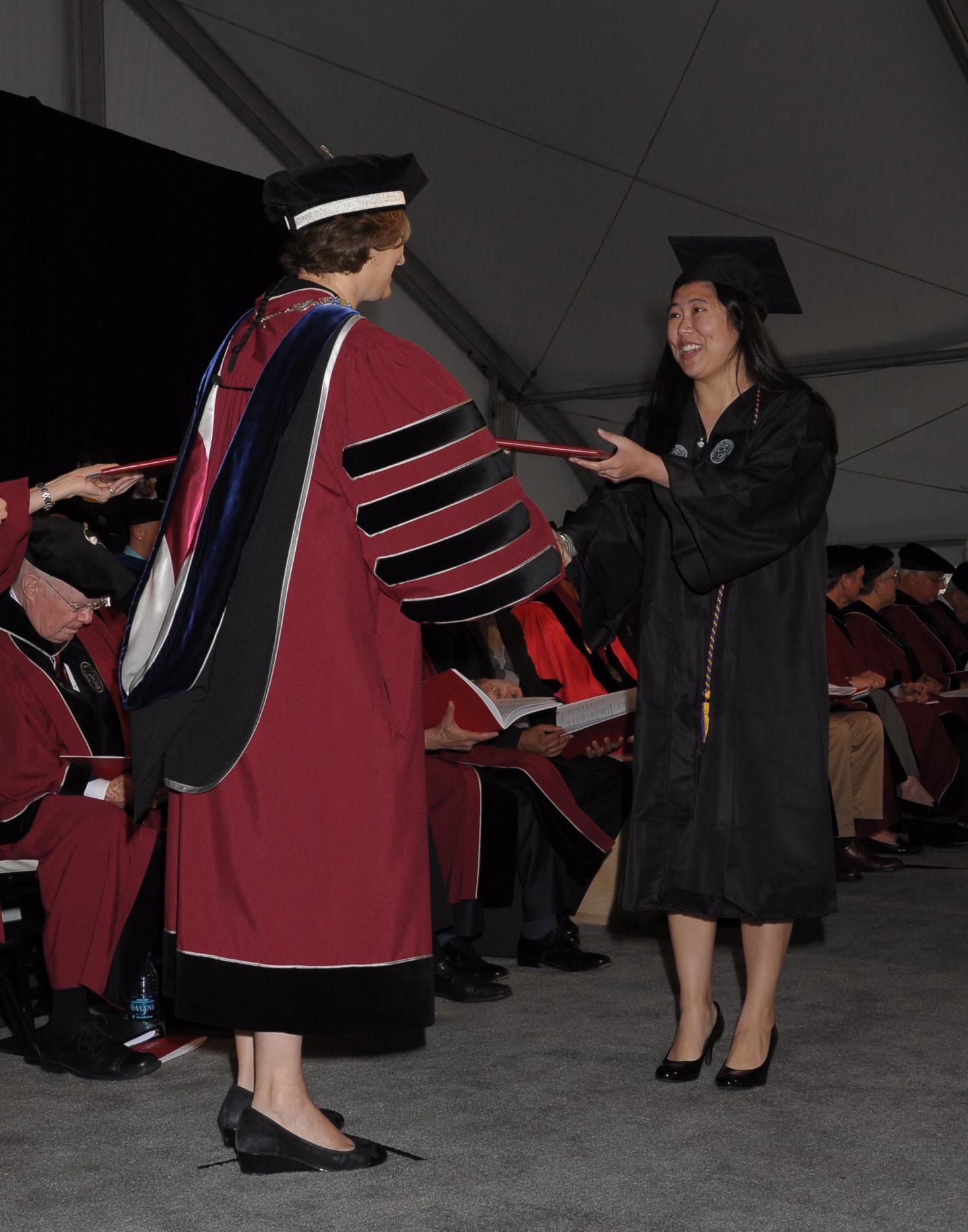 Laurie Leshin giving diploma to student