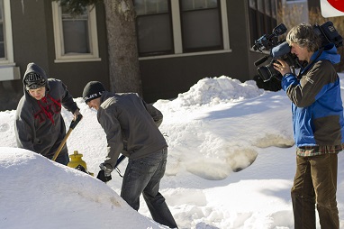 WPI students Alex Bell, left, and Steve Como dig out a buried hydrant on Wachusett Street as a WBZ Channel 4 cameraman shoots.