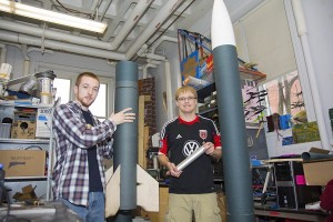 Kyle Foster, left, and Jeffrey Tolbert display some of the rockets they will enter into competition.
