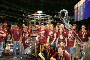 The WPI/Mass Academy FIRST Robotics team in the Georgia Dome with the championship trophy.