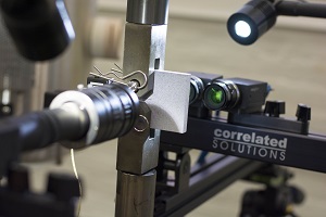 Three high-speed cameras are used on an aluminum alloy specimen tested for fatigue resistance.