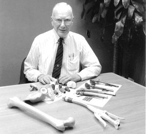 Noiles in 1992 with some of his inventions, including a surgical stapler (foreground) and knee prostheses.