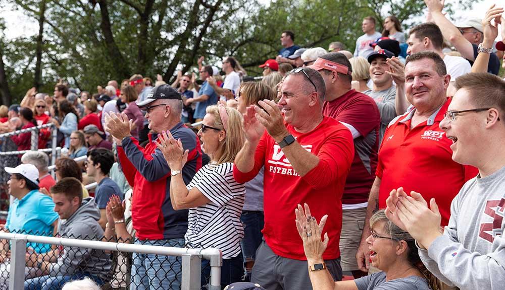 Crowds of family members fill the bleachers of Alumni Stadium during the Family Weekend football game.