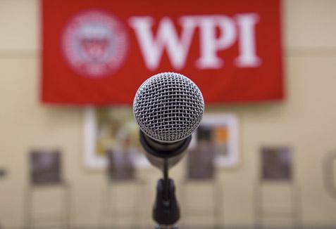 microphone with a WPI banner in the background