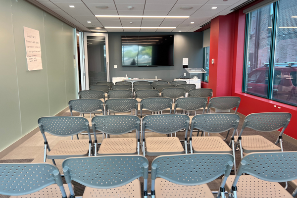 boardroom setup theater style with event chairs facing display monitor