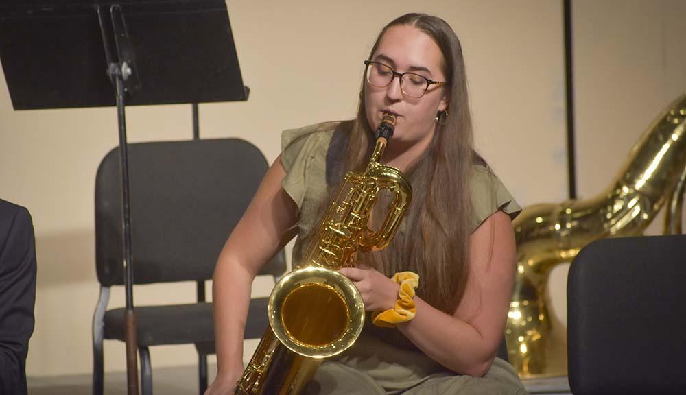 A student plays the saxophone during a band performance.