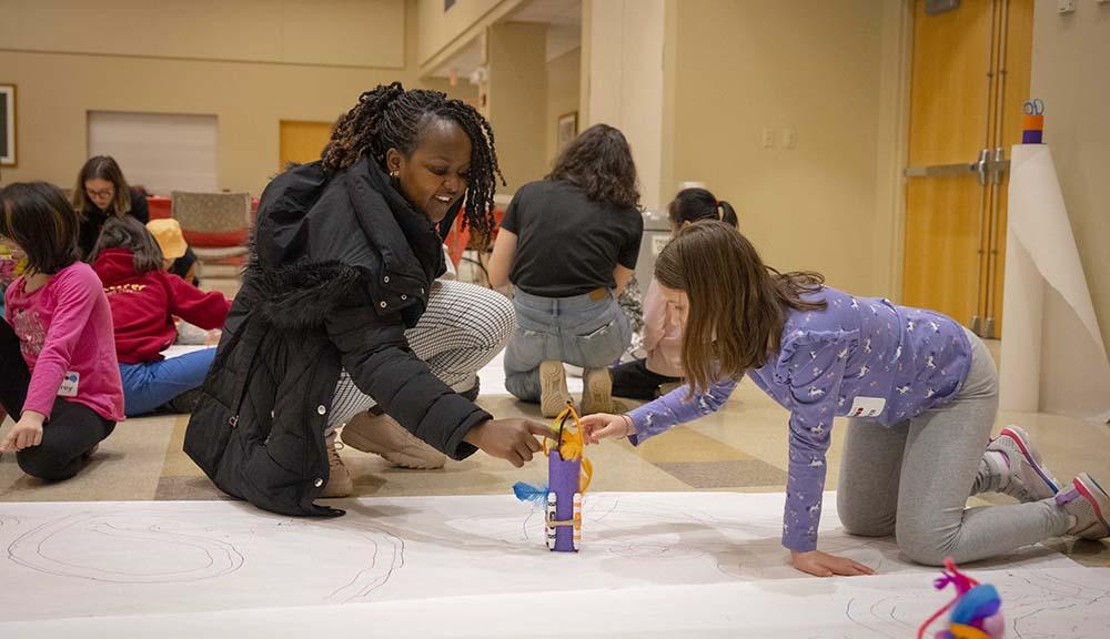 Pre-college students participate in a hands-on learning activity on campus.
