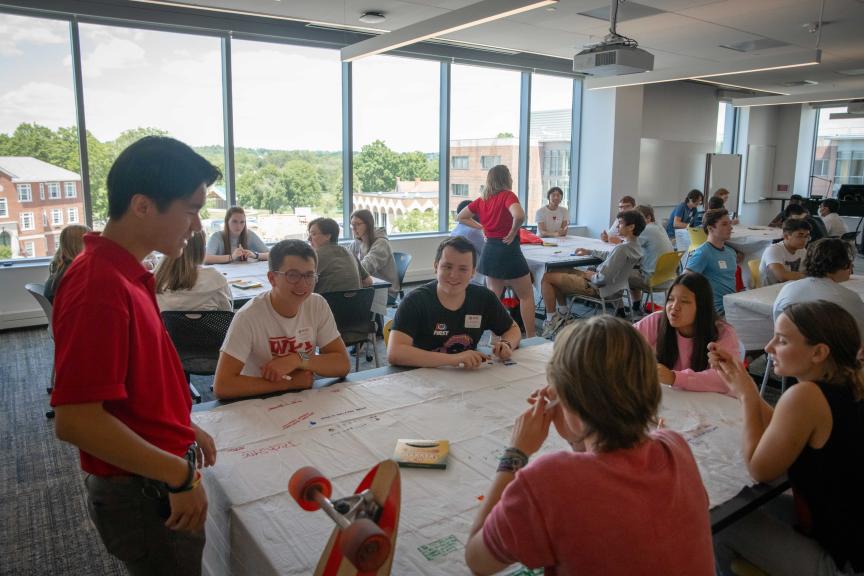 Students chat in a classroom during last year's First-Year Welcome Experience.