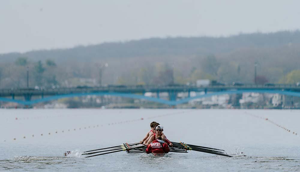Members of the men's crew team row on Lake Quinsigamond.