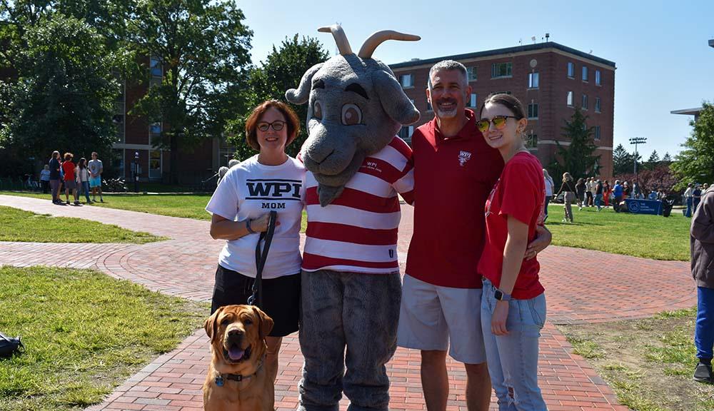A family poses for a photo with Gompei.