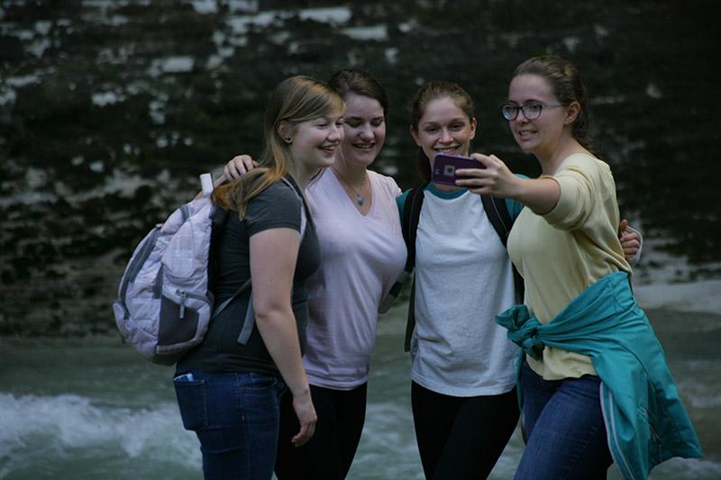 Students taking a group selfie.