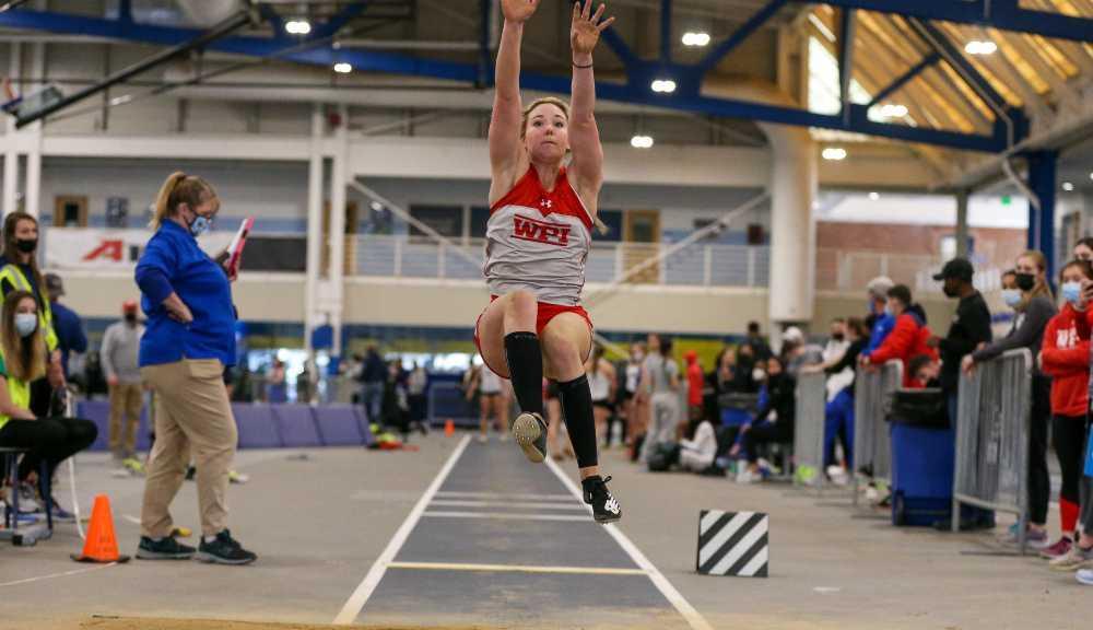 Katie Nippert mid-air during a long jump