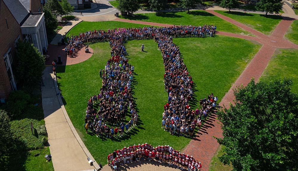 An aerial photo of the Class of 2027 arranged into a pi symbol on the quad.