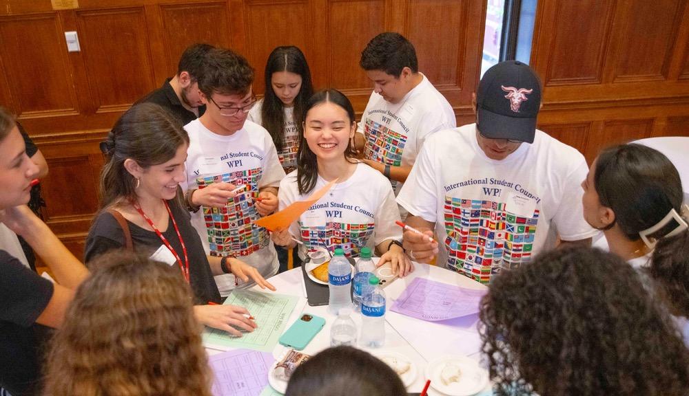 students standing at table at international student breakfast 2023