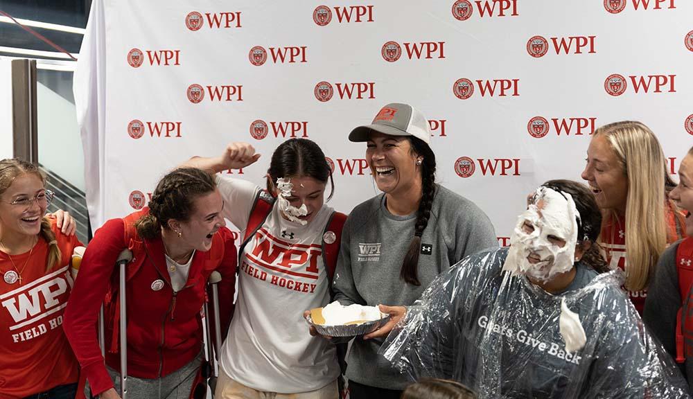 Members of the field hockey team laugh after pieing a teammate in the face on Giving Day.
