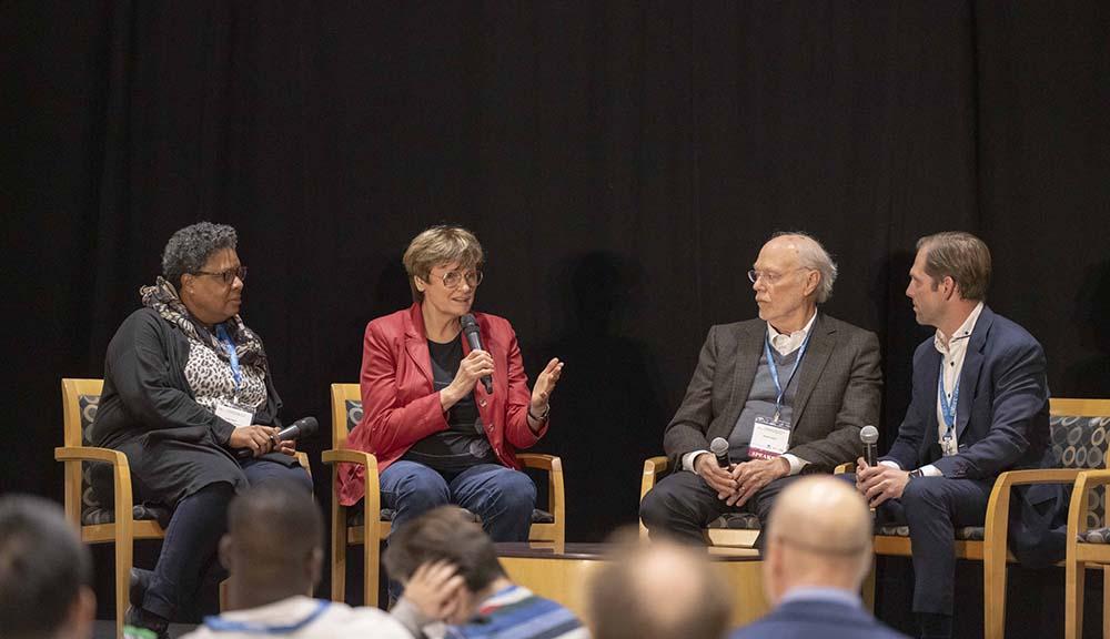Panelists at the Nature Conference held at WPI hold a discussion onstage.