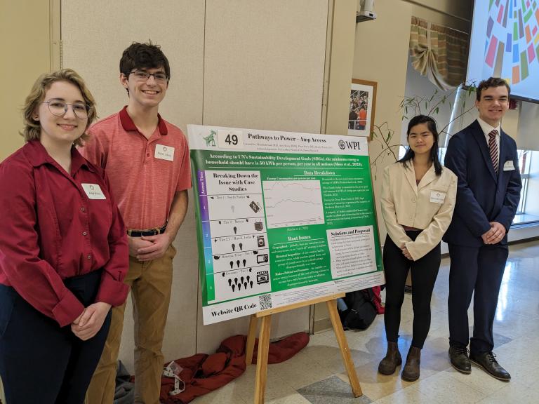 four students with poster on great problems seminar poster day