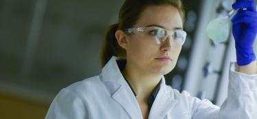Person working in lab looking at experiment