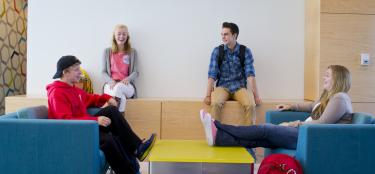 Student sitting in a group at the housing lounge