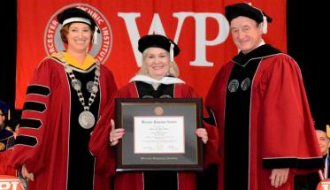 Deborah Wince-Smith, center, receives an honorary doctorate from WPI President Laurie Leshin, left, and WPI Board Chairman Jack Mollen