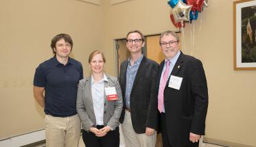 Mass Academy alumni Andy Ross, Maggie Frost Groll, and Tommy Boucher pose with Director Michael Barney.
