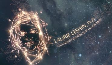 Laurie Leshin's image is projected on the ceiling of the Grand Central terminal in the form of a constellation. In gold text next to her is "Laurie Leshin, PhD. Geochemist in search of life on Mars." 