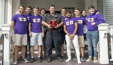 WPI police officer with fraternity brothers