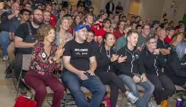Members of team Bite Force sit and cheer with Laurie Leshin and other members of the WPI community during the BattleBots viewing party in the Odeum last Friday.