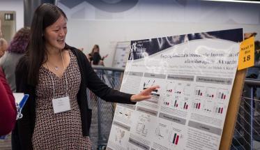 A Next-in-Bio participant presents her poster to attendees.