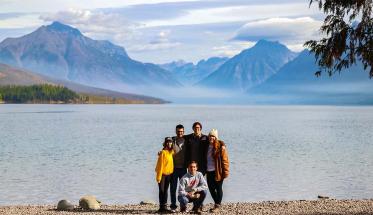 Members of the Glacier National Park Project Center team gather in front of a mountain for a picturesque photo.