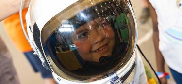 Child in space helmet at WPI TouchTomorrow