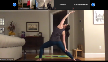 Angela Rodriguez, assistant professor of psychology, guides her yoga class into a Reverse Warrior pose. 