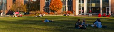 WPI Students sitting on the green at WPI