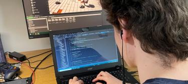 Student coding on a computer
