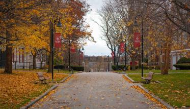 View of walkway on Campus, WPI banners and benches in a fall setting