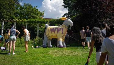 Students gather around a giant inflatable Gompei on Higgins Lawn.