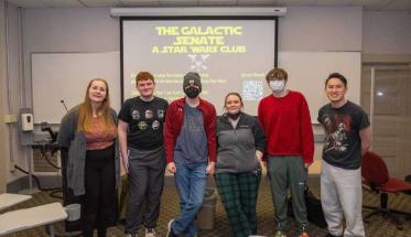 Members of the Star Wars Club smile for a photo during a trivia night event.