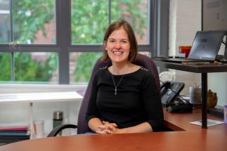 Assistant Professor Sarah Stanlick sitting at her desk