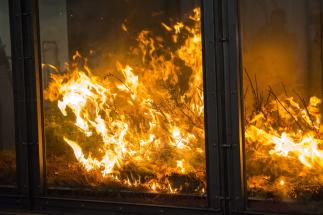 An experimental fire burns in a wind tunnel at WPI