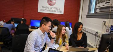 Picture of 3 students working at a computer at the WPI data science innovation lab