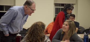 WPI faculty members interacting with student teams in a project-based course