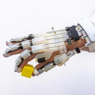 robotic hand attachment holding yellow cube