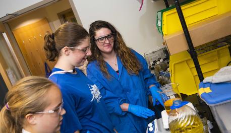 Roisin Donnelly (background) works in the lab with girls from the Innovations in Biomedical Engineering camp.