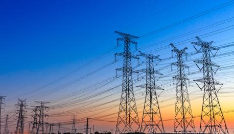 A photo of electrical towers at dusk.