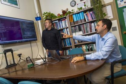 WPI professor Alex Wyglinski (right) and graduate student Max Li are using techniques to improve wireless communications in space.